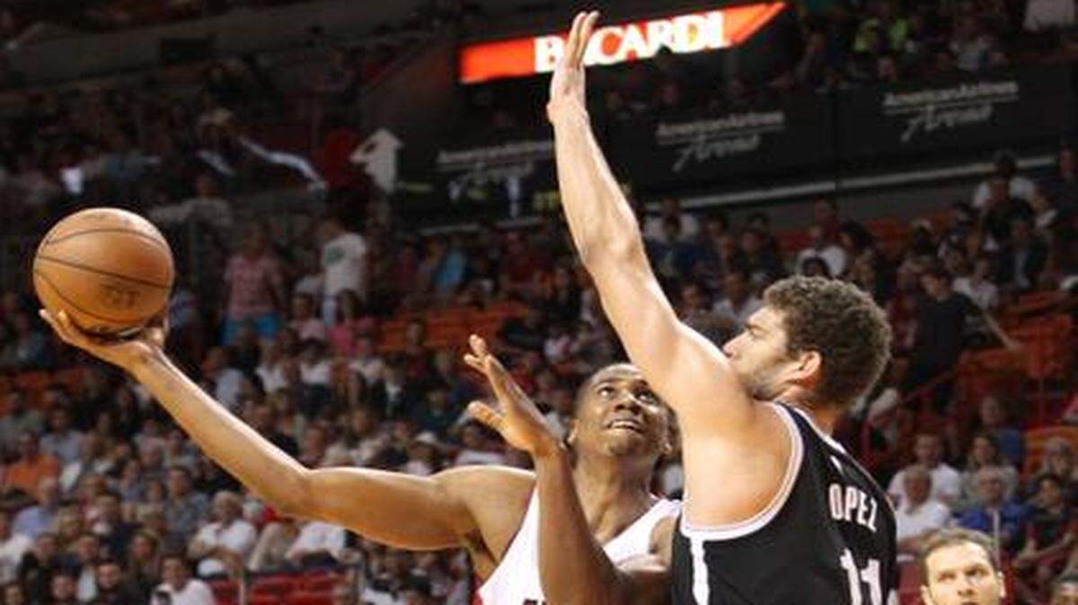 
Miami Heat center Hassan Whiteside goes to the basket to score against Brooklyn Nets center Brook Lopez in the second quarter during a game at AmericanAirlines Arena on Sunday, Jan. 4, 2015.
