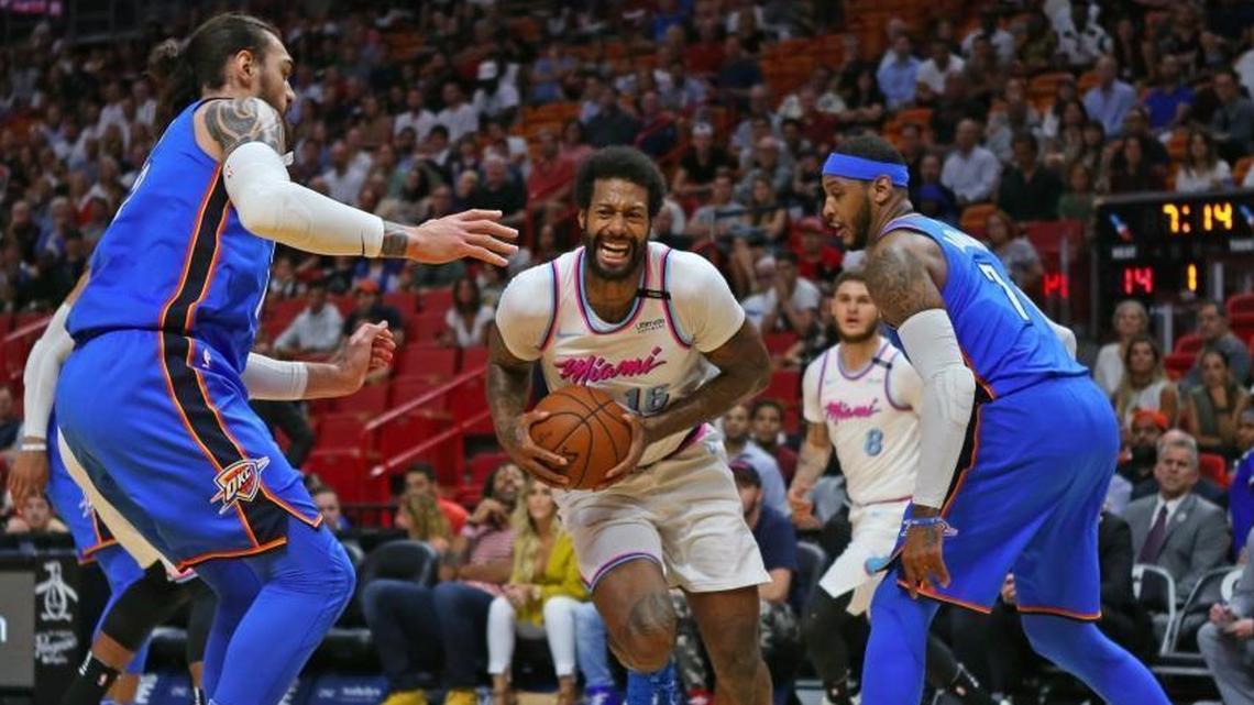 Miami Heat forward James Johnson drives to the basket against Oklahoma City Thunder center Steven Adams and forward Carmelo Anthony during the first quarter at the AmericanAirlines Arena in Miami on Monday, April 9, 2018.
