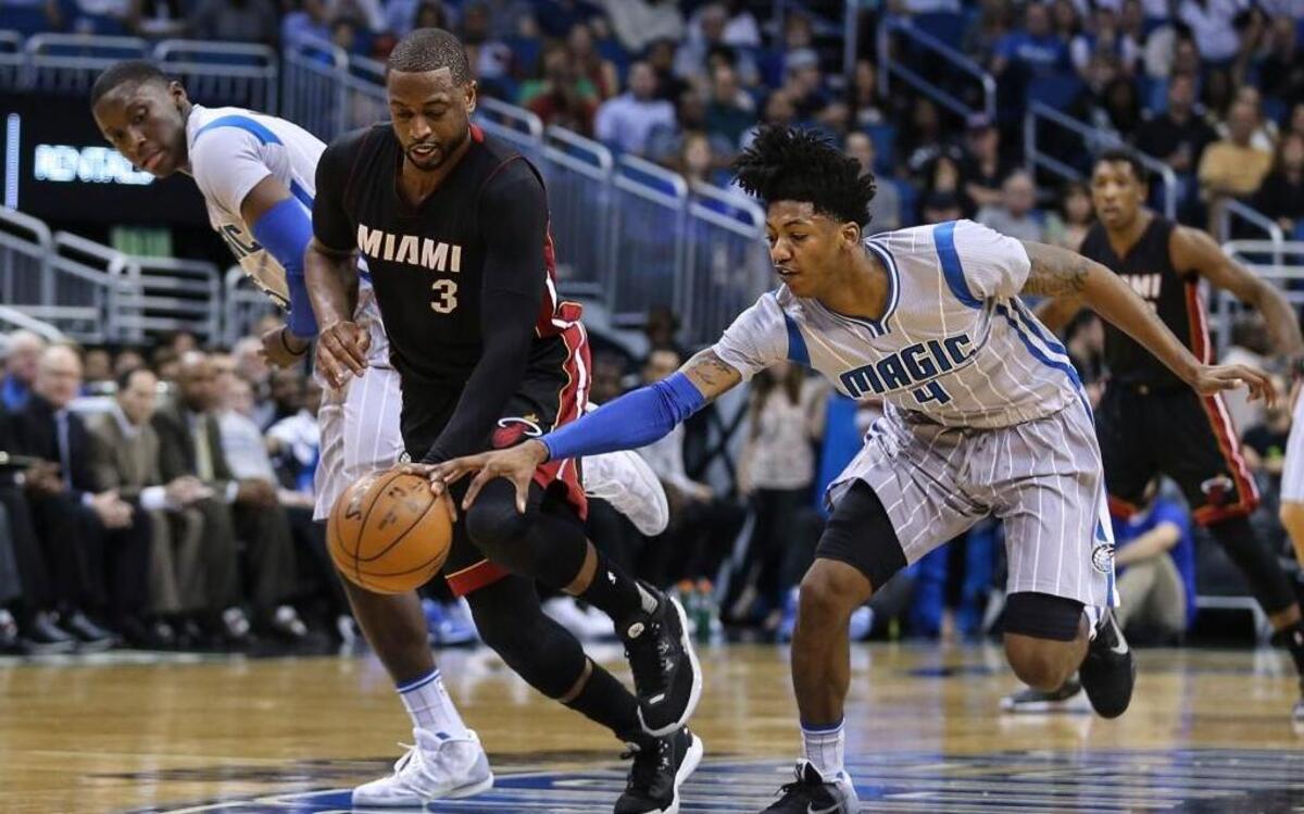 Miami Heat guard Dwyane Wade (3) steals the ball from Orlando Magic guard Elfrid Payton (4) during the first half of an NBA basketball game in Orlando, Fla., Friday, April 8, 2016.