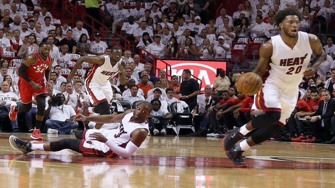 Dwyane Wade, looks on as Justise Winslow of the Miami Heat, drives full speed to the basket against the Toronto Raptors, in the first quarter of Game 6 of the NBA Eastern Conference semifinal series at AmericanAirlines Arena in Miami on Friday, May 13, 2016.
