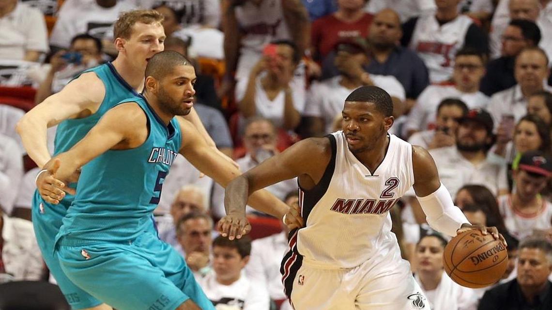 Joe Johnson, of the Miami Heat, drives to the basket against Cody Zeller and Nicolas Batum, front left, of the Charlotte Hornets, in the third quarter of Game 2 of the Miami Heat's first-round series with the Charlotte Hornets at AmericanAirlines Arena in Miami on Wed., April 20, 2016. Batum left the game with an injury.