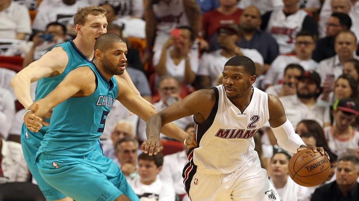 Joe Johnson, of the Miami Heat, drives to the basket against Cody Zeller and Nicolas Batum, front left, of the Charlotte Hornets, in the third quarter of Game 2 of the Miami Heat's first-round series with the Charlotte Hornets at AmericanAirlines Arena in Miami on Wed., April 20, 2016. Batum left the game with an injury.