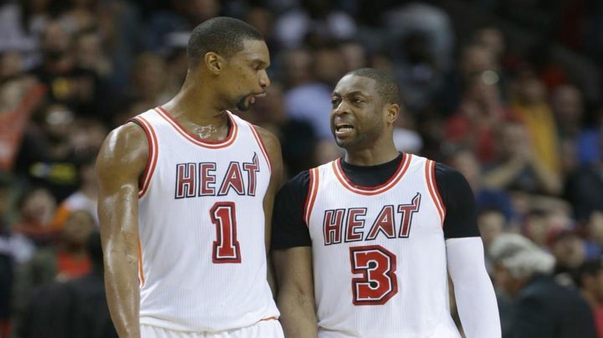 Miami Heat forward Chris Bosh (1) and guard Dwyane Wade (3) talk during the second half of an NBA basketball game against the Los Angeles Clippers, Sunday, Feb. 7, 2016, in Miami. The Clippers defeated the Heat 100-93.