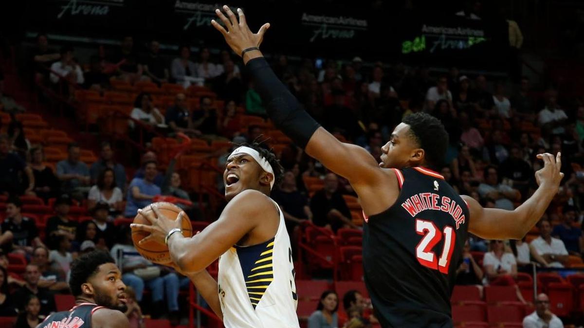 Indiana Pacers center Myles Turner (33) looks to the basket between Miami Heat center Hassan Whiteside (21) and Heat forward Justise Winslow (20) in the third quarter of an NBA basketball game, Sun., Nov. 19, 2017, in Miami. Indiana won the game 120-95.