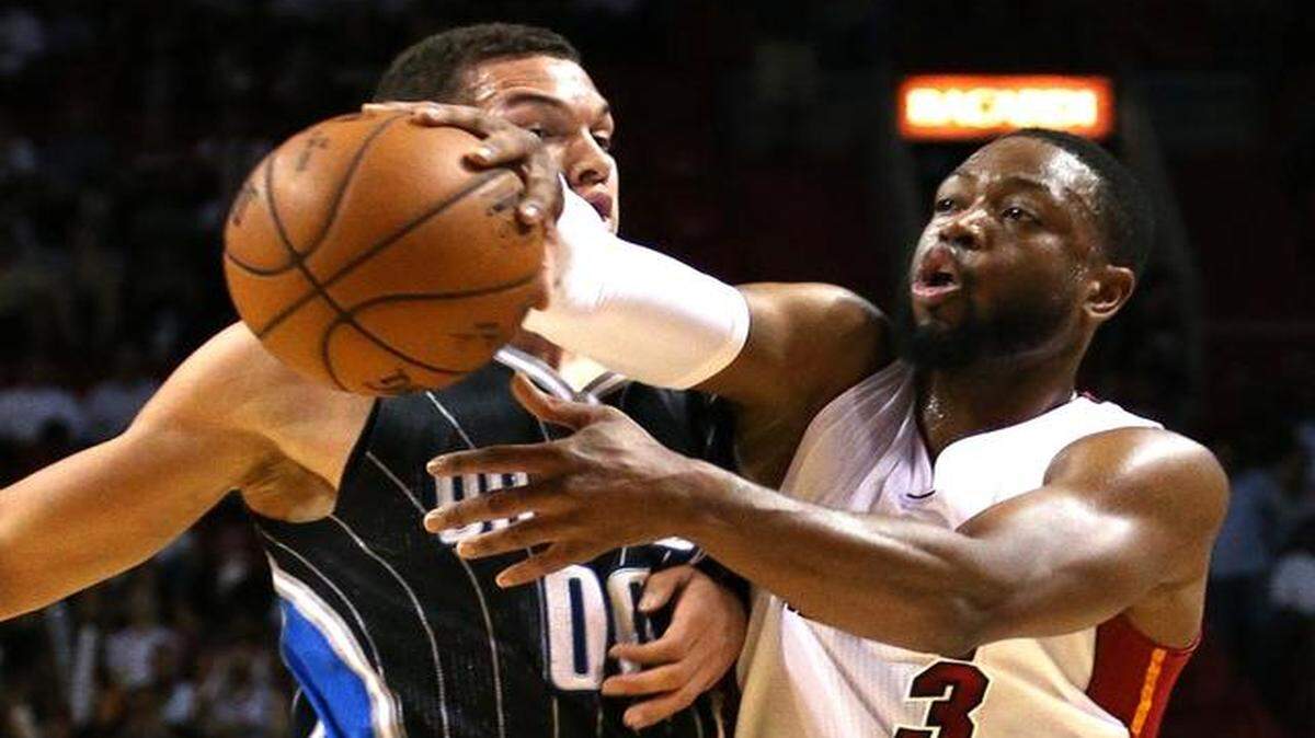 
Miami Heat’s Dwayne Wade passes around Orlando Magic’s Aaron Gordan in the first quarter at AmericanAirlines Arena in Miami on April 13, 2015.
