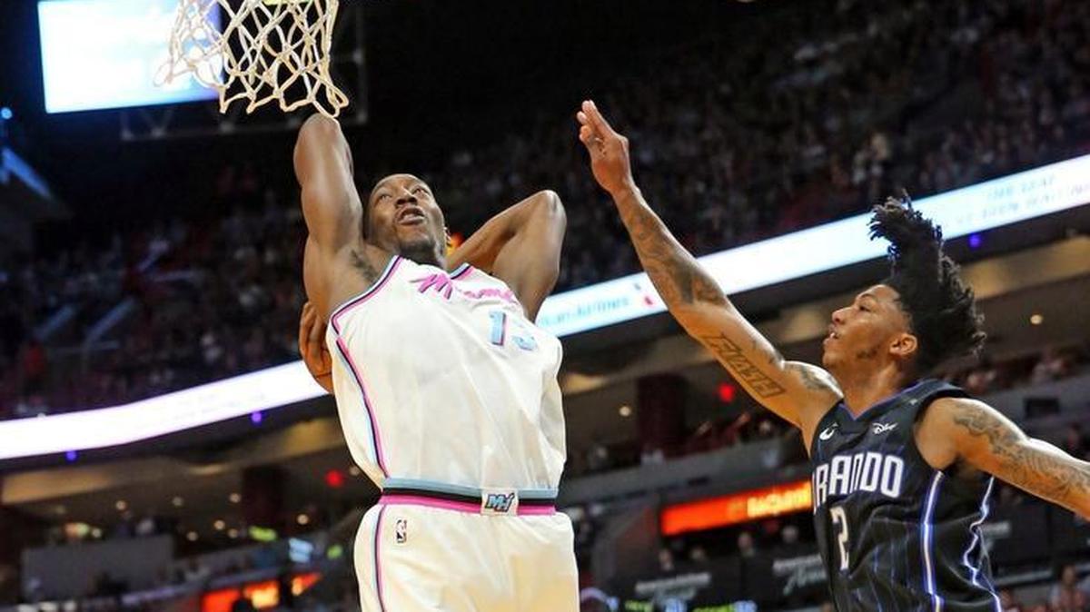 The Miami Heat’s Bam Adebayo (13) dunks the ball while the Orlando Magic’s Elfrid Payton (2) defends in the second quarter at the AmericanAirlines Arena in Miami on Monday, Feb. 5, 2018.