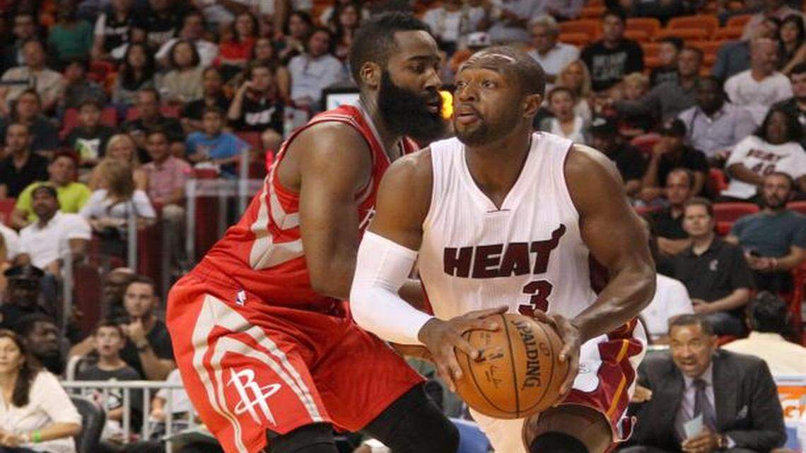 
Dwyane Wade goes to the basket against James Harden in the first quarter during a preseason game between the Miami Heat and Houston Rockets at AmericanAirlines Arena in Miami on Tuesday, October 21, 2014.
