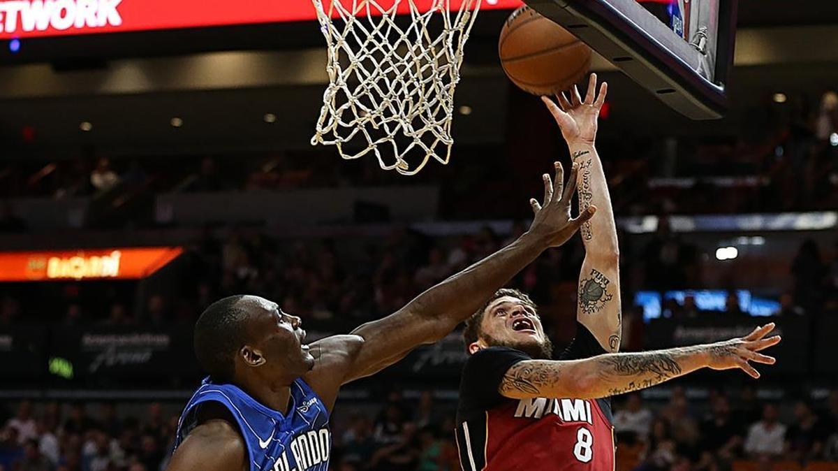 Miami Heat guard Tyler Johnson goes to the basket against Magic's center Bismack Biyombo in the first quarter of the Miami Heat vs Orlando Magic, NBA game at AmericanAirlines Arena in Miami on Tuesday, Dec. 26, 2017.
