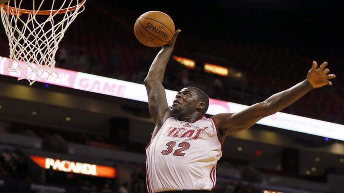 
James Ennis dunks during the Miami Heat's Red, White & Pink Game at AmericanAirlines Arena in Miami on Wednesday, October 1, 2014.
