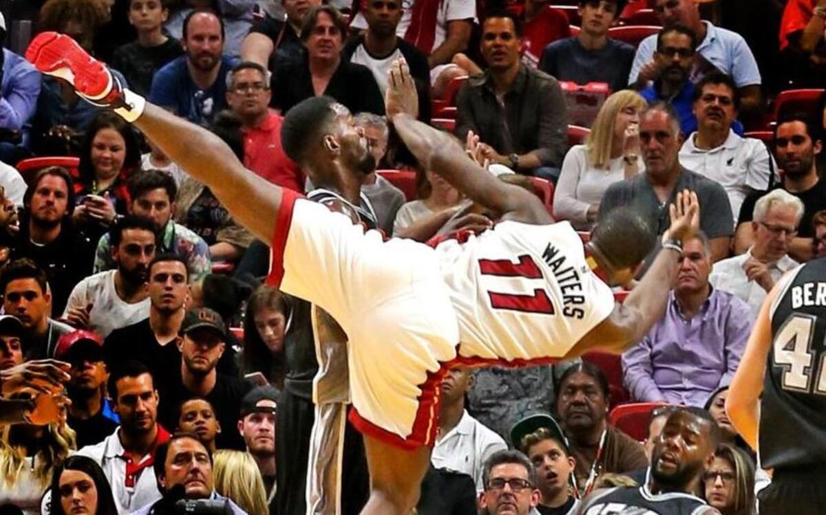 Miami Heat's Dion Waiters collides with San Antonio Spurs' Jonathan Simmons in the first quarter at the AmericanAirlines Arena in Miami, Florida on Sun., Oct. 30, 2016.