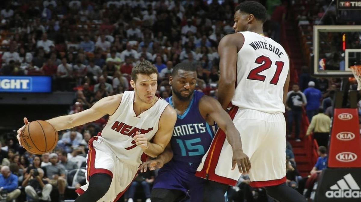 Miami Heat guard Goran Dragic (7) drives past Charlotte Hornets guard Kemba Walker (15) in the first quarter as the Miami Heat host the Charlotte Hornets in the home opener at AmericanAirlines Arena on Fri., Oct. 28, 2016.