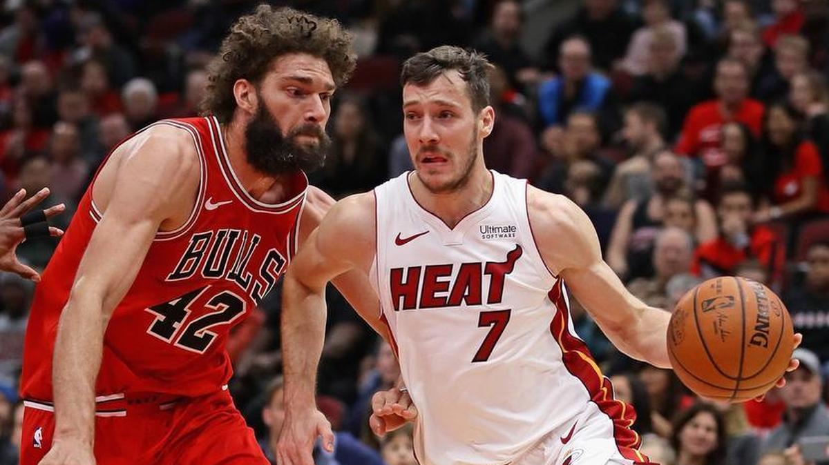 Goran Dragic of the Miami Heat drives around Robin Lopez of the Chicago Bulls at the United Center on January 15, 2018 in Chicago, Illinois.