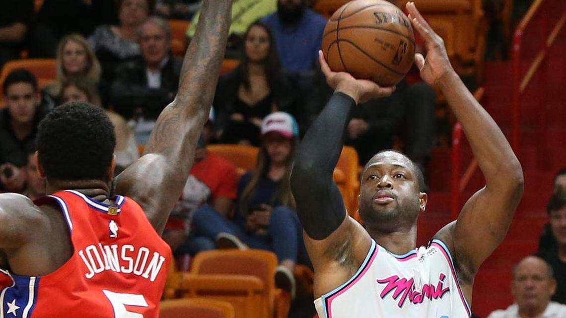 The Miami Heat's Dwyane Wade (3) shoots a 3-pointer against the Philadelphia 76ers' Amir Johnson in the first quarter at AmericanAirlines Arena in Miami on Thursday, March 8, 2018. The Heat won, 108-99.