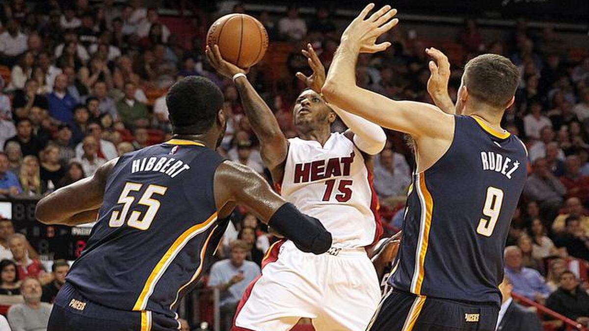 
 Mario Chalmers shoots over Roy Hibbert and Damjan Rudez in the first quarter of the Miami Heat's game against the Indiana Pacers at AmericanAirlines Arena in Miami on Wednesday, Nov. 12, 2014.
