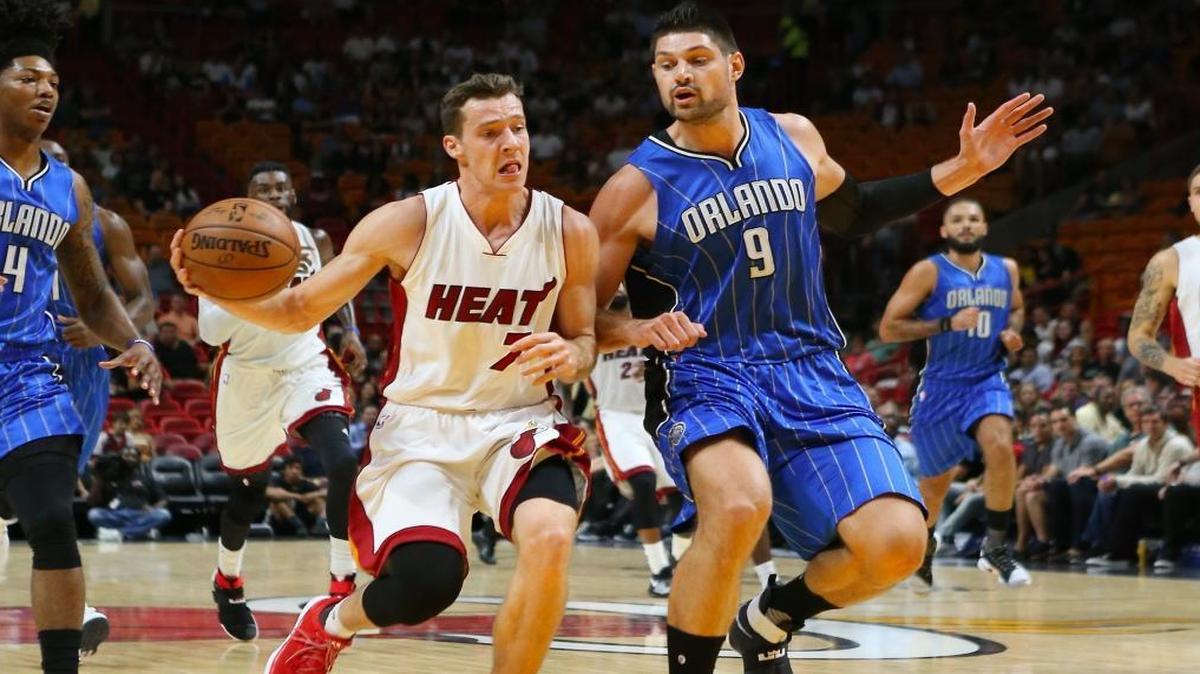 Miami Heat guard Goran Dragic drives against the Orlando Magic center Nikola Vucevic, 9, and guard Elfrid Payton in the first quarter of an preseason NBA basketball game at AmericanAirlines Arena on Tues., Oct. 18, 2016, in Miami.