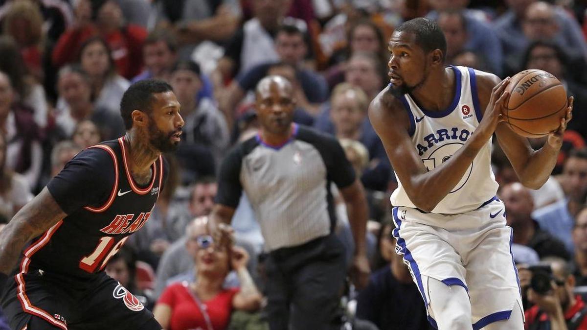 Miami Heat forward James Johnson, shown guarding Golden State Warriors’ Kevin Durant earlier this season, suffered a lower leg injury during the first quarter of the Heat’s basketball game at the AmericanAirlines Arena in Miami on Sat., Dec. 16, 2017.