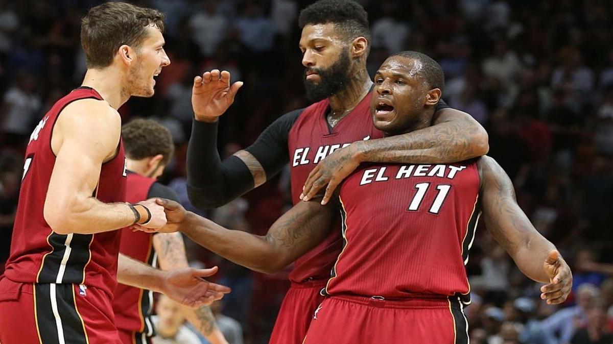 Miami Heat forward James Johnson and guard Goran Dragic congratulate Dion Waiters as they lead in the fourth quarter of the Miami Heat and Charlotte Hornets game at AmericanAirlines Arena in Miami on Wed., March 8, 2017.