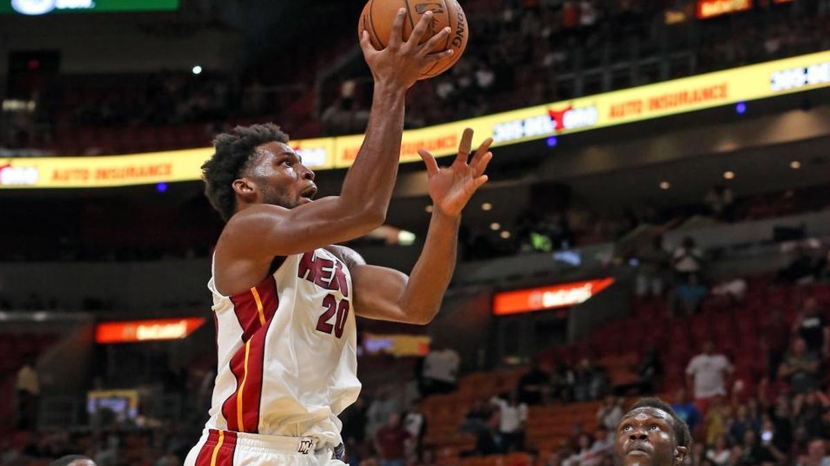 Miami Heat Justise Winslow makes the winning basket at the end of the fourth quarter over Charlotte Hornets Mangok Mathiang at the AmericanAirlines Arena in Miami, Florida, October 9, 2017.