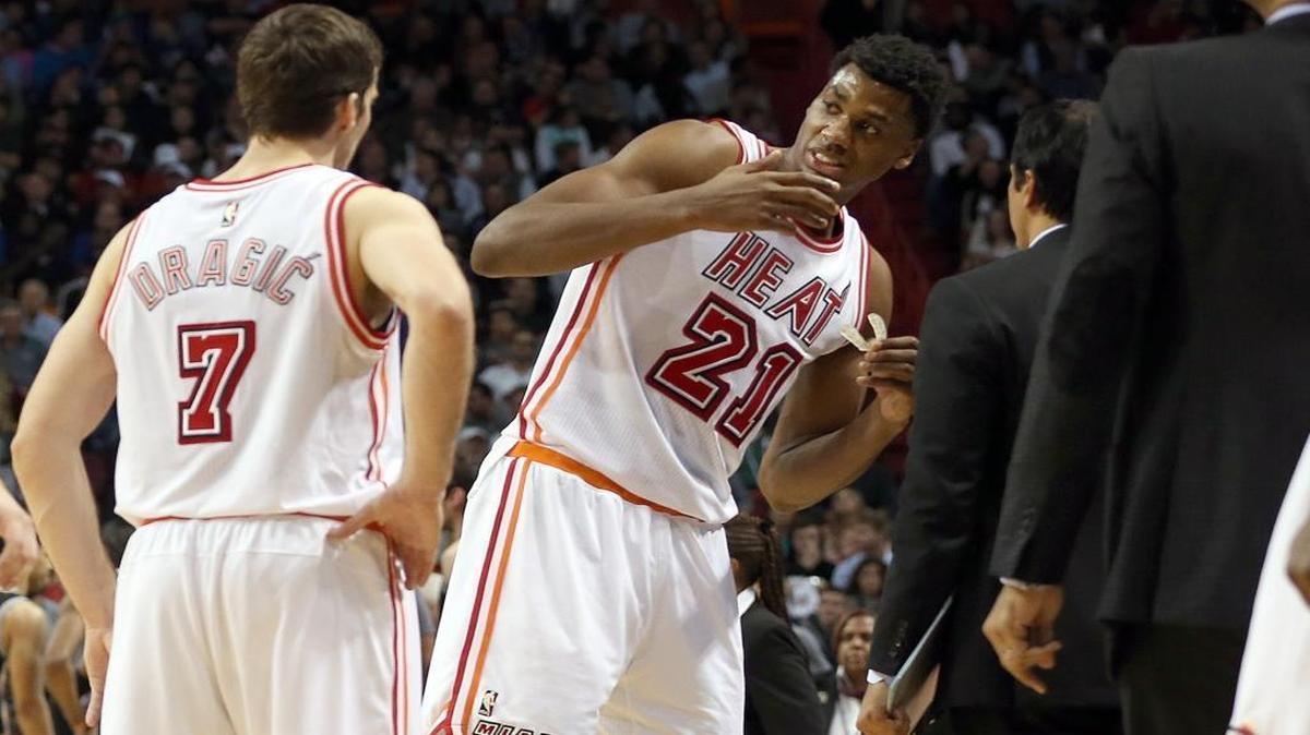 Hassan Whiteside of the Miami Heat talks to head coach Erik Spoelstra, right, as teammate Goran Dragic looks on after Whiteside was whistled for a Grade 2 flagrant foul and ejected after elbowing Spurs center Boban Marjanovic in the fourth quarter at AmericanAirlines Arena in Miami on Tuesday, February 9, 2016.