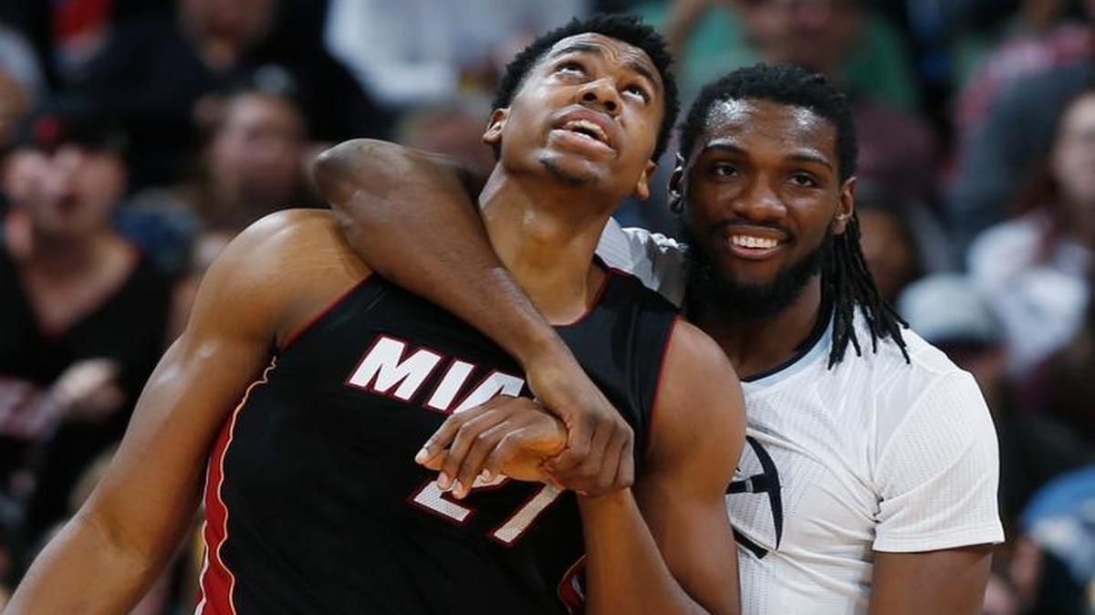 Denver Nuggets forward Kenneth Faried, right, hugs Miami Heat center Hassan Whiteside after Whiteside was fouled by Faried during the second half Friday, Jan. 15, 2016, in Denver. Miami won 98-95.