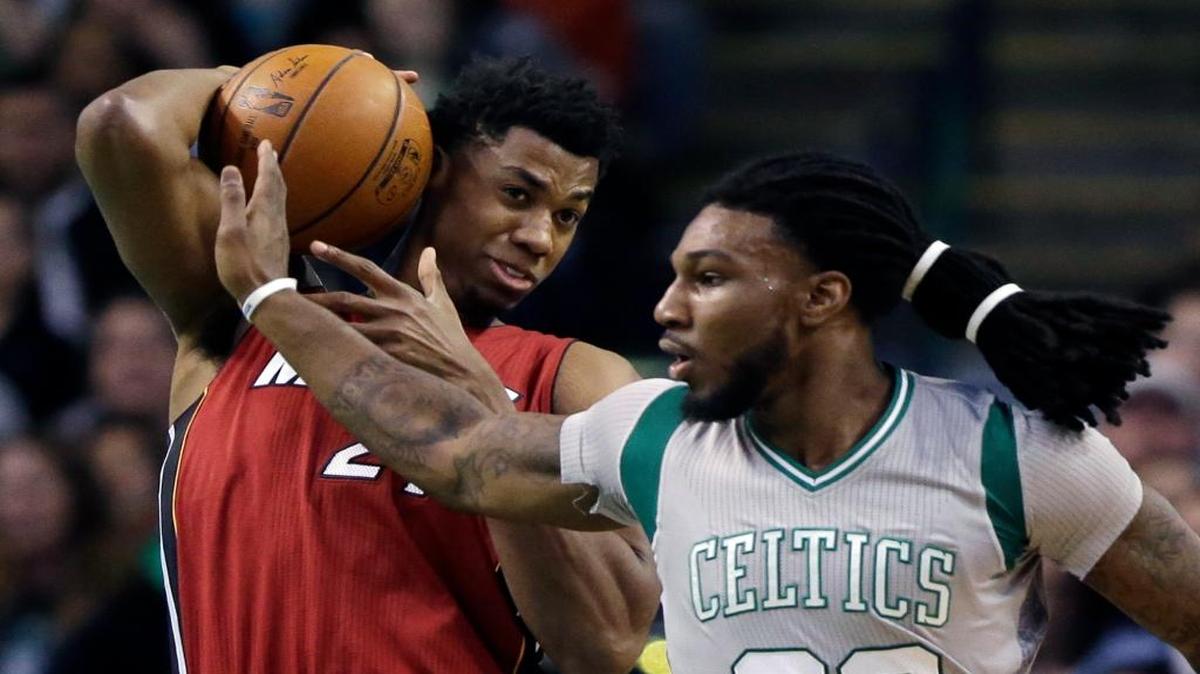Miami Heat center Hassan Whiteside pulls down a defensive rebound in front of Boston Celtics forward Jae Crowder (99) in the first quarter of an NBA basketball game, Wednesday, April 13, 2016, in Boston.