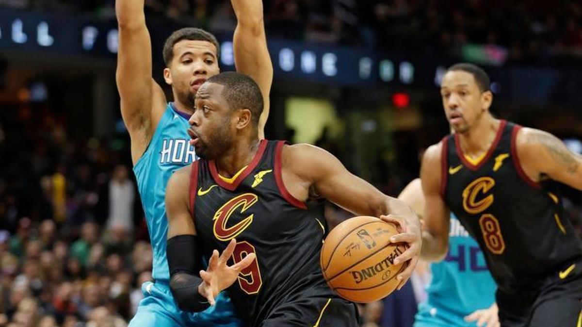 Cleveland Cavaliers' Dwyane Wade (9) drives past Charlotte Hornets' Michael Carter-Williams (10) in the first half of an NBA basketball game on Friday, Nov. 24, 2017, in Cleveland.
