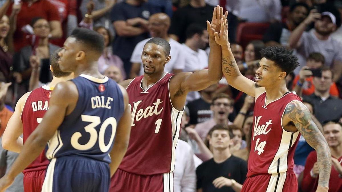 Gerald Green, greets Chris Bosh, of the Miami Heat, after a Bosh basket to break a tie score against the New Orleans Pelicans in the fourth quarter of a game at AmericanAirlines Arena in Miami on Thursday, December 25, 2015.