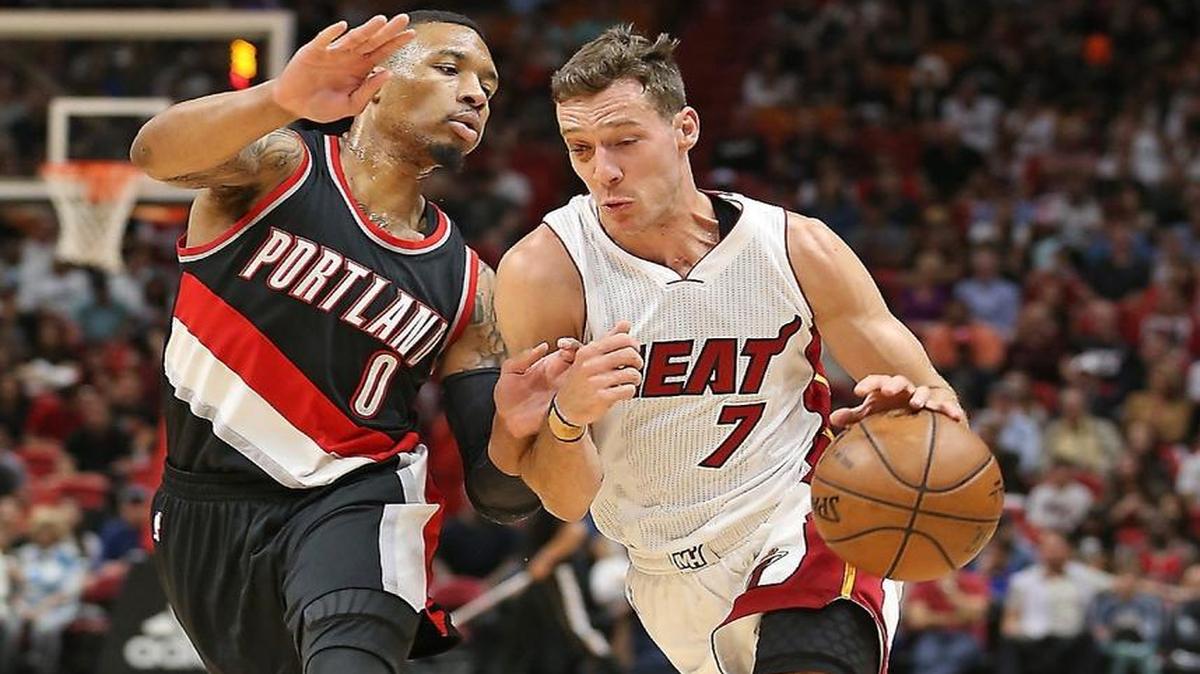The Heat's (7) Goran Dragic drives to the basket past Portland's #0 Damian Lillard as the Miami Heat host the Portland Trail Blazers on Sunday, March 19, 2017.