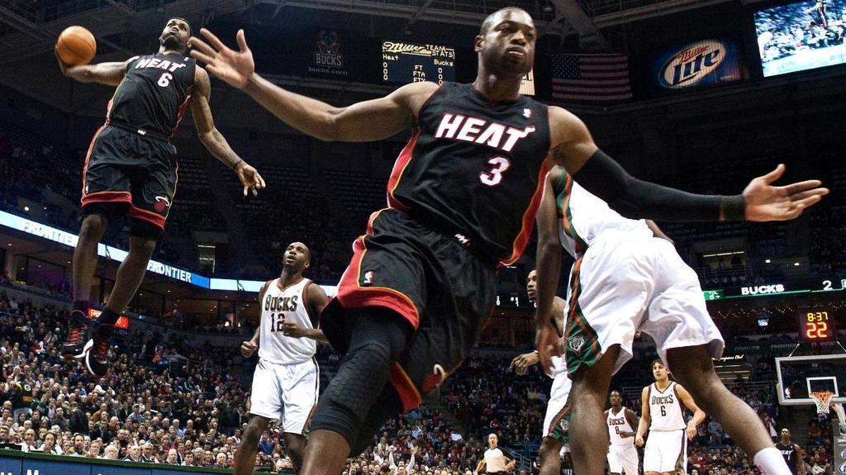 Miami Heat’s Dwyane Wade (3) reacts as teammate LeBron James (6) goes up for a dunk during a Dec. 6, 2010, game against the Milwaukee Bucks.