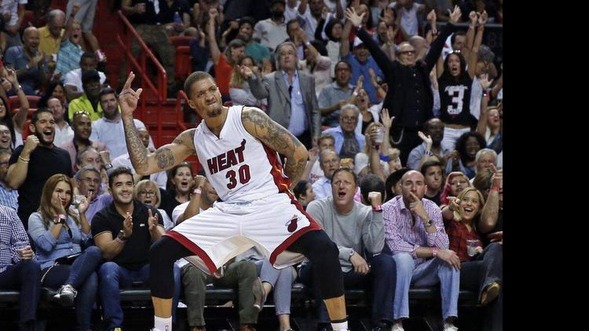 
Heat fans and Michael Beasley celebrate his second quarter three-pointer as the Miami Heat hosts the Chicago Bulls at the AmericanAirlines Arena on Thursday, April 9, 2015.
