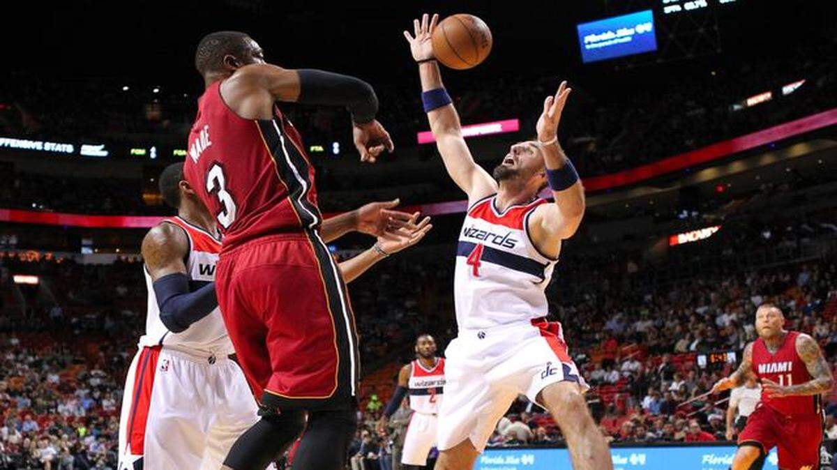 
Miami Heat guard Dwyane Wade passes the ball against Washington Wizards center Marcin Gortat during the first quarter of an NBA basketball game at the AmericanAirlines Arena in Miami on Dec. 19, 2014.
