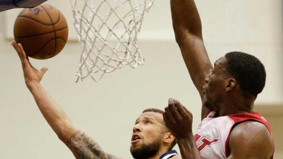 Indiana Pacers’ Trey McKinney-Jones takes a shot against Miami Heat’s Bam Adebayo during the first half of an NBA summer league basketball game in Orlando, Fla. A handful of players are getting to play for two NBA teams this summer, a grind they hope pays off down the road. Trey McKinney Jones, Dylan Ennis and Naz Mitrou-Long are among those who played for one team in Orlando and Salt Lake City, and will switch jerseys once they get to the NBA’s biggest summer league in Las Vegas.