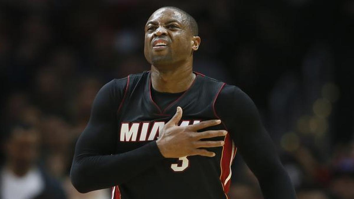 Miami Heat's Dwyane Wade holds himself and winces against the Los Angeles Clippers during the first half of an NBA basketball game, Wednesday, Jan. 13, 2016, in Los Angeles.
