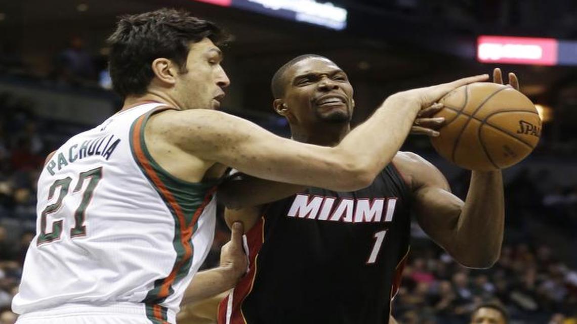 
Milwaukee Bucks' Zaza Pachulia knocks the ball away from Miami Heat's Chris Bosh during the first half of an NBA basketball game Friday, Dec. 5, 2014, in Milwaukee.
