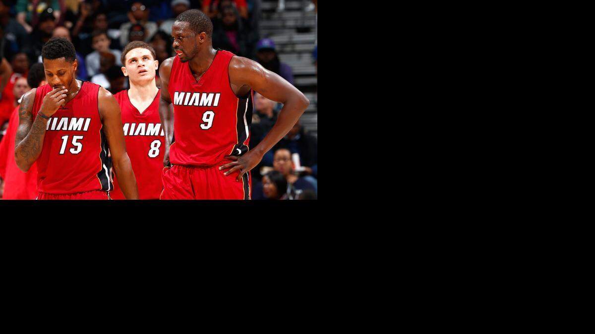 
Mario Chalmers, Tyler Johnson and Luol Deng of the Miami Heat walk off the court at the end of the first half against the Atlanta Hawks at Philips Arena on March 27, 2015 in Atlanta, Georgia. Atlanta led 55-37 at the half and won 99-86.
