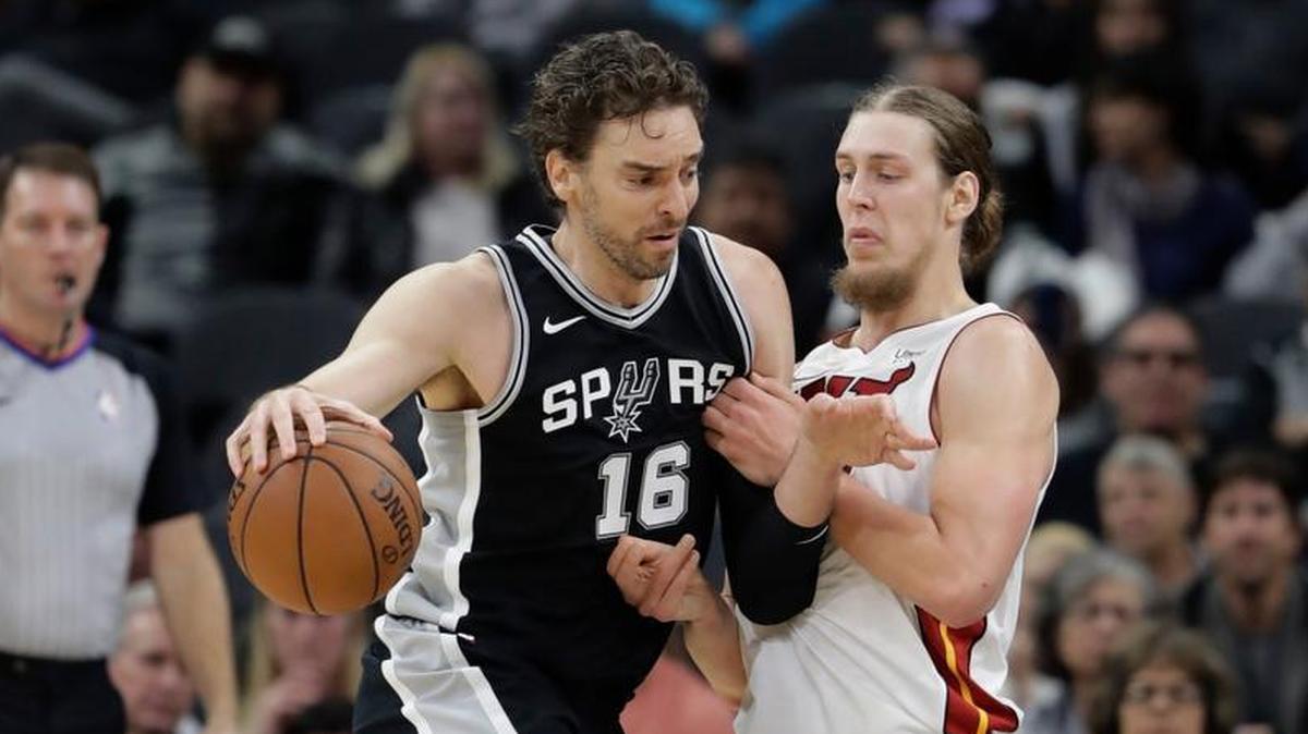 San Antonio Spurs center Pau Gasol (16) drives around Miami Heat center Kelly Olynyk during the first half of an NBA basketball game Wednesday, Dec. 6, 2017, in San Antonio.
