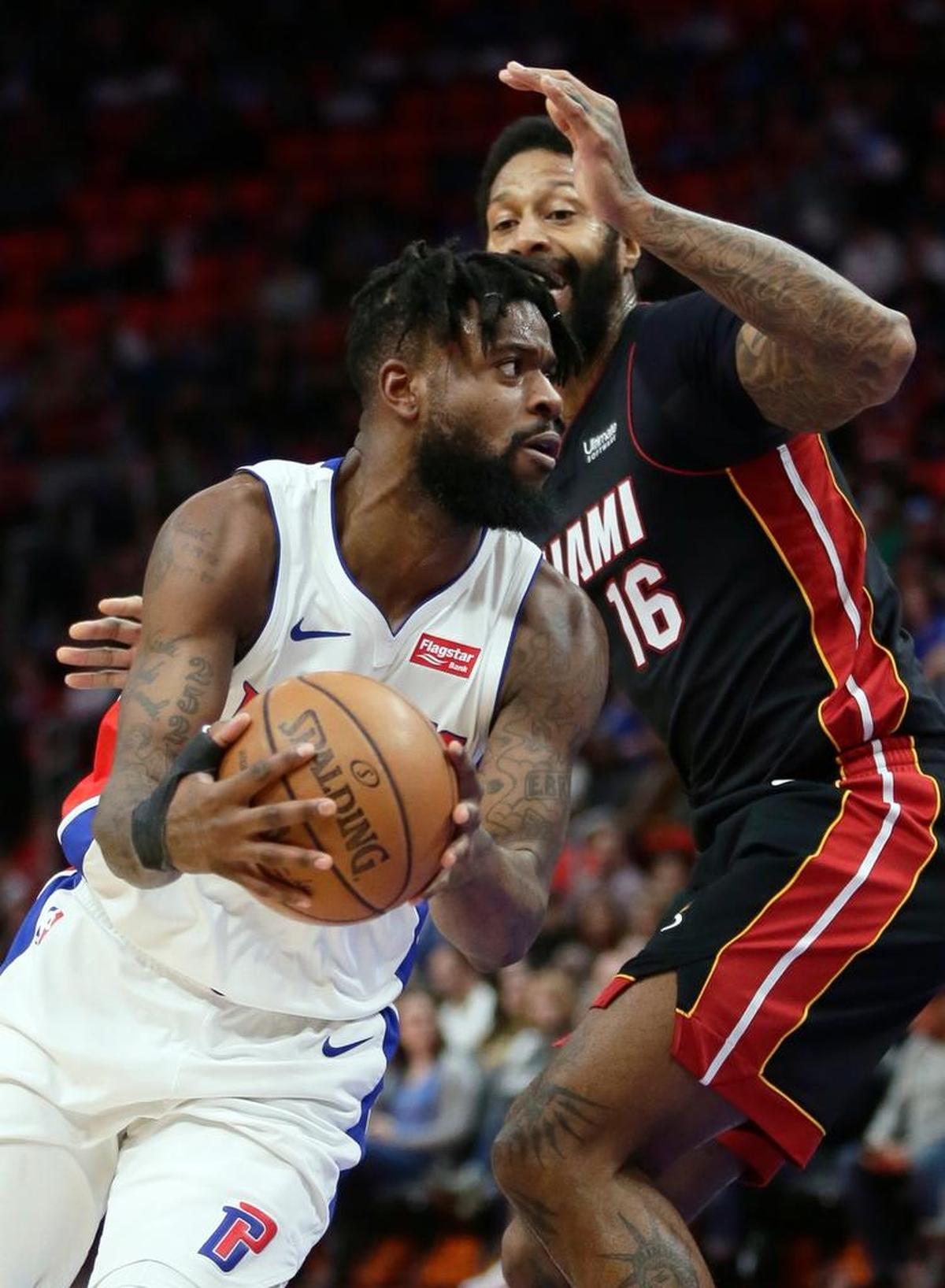 Detroit Pistons forward Reggie Bullock, left, drives to the basket against Miami Heat forward James Johnson (16) during the first half of an NBA basketball game Saturday, Feb. 3, 2018, in Detroit.