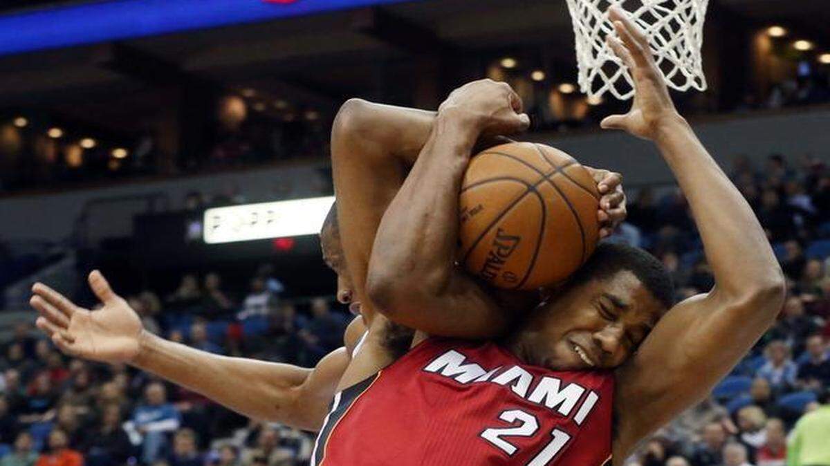 
Minnesota Timberwolves forward Andrew Wiggins, left, and Miami Heat center Hassan Whiteside (21) struggle for possession of a rebound in the first quarter of an NBA basketball game in Minneapolis on Feb. 4, 2015. A jump ball was called on the play.
