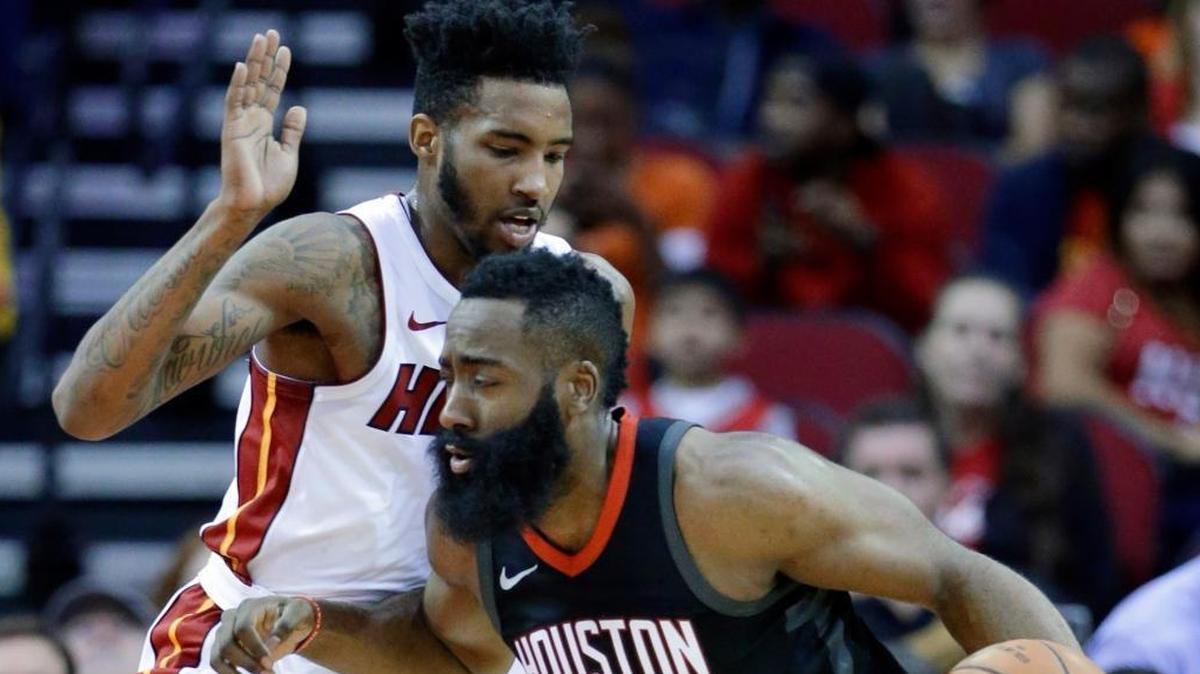 Houston Rockets guard James Harden (13) drives around Miami Heat forward Derrick Jones Jr. (5) during the first half of an NBA basketball game Monday, Jan. 22, 2018, in Houston.