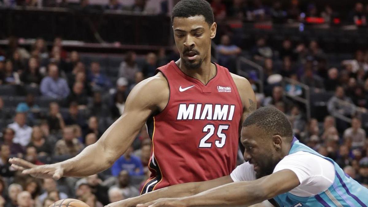 Charlotte Hornets' Kemba Walker (15) and Miami Heat's Jordan Mickey (25) chase the ball during the first half of Friday’s game in Charlotte.