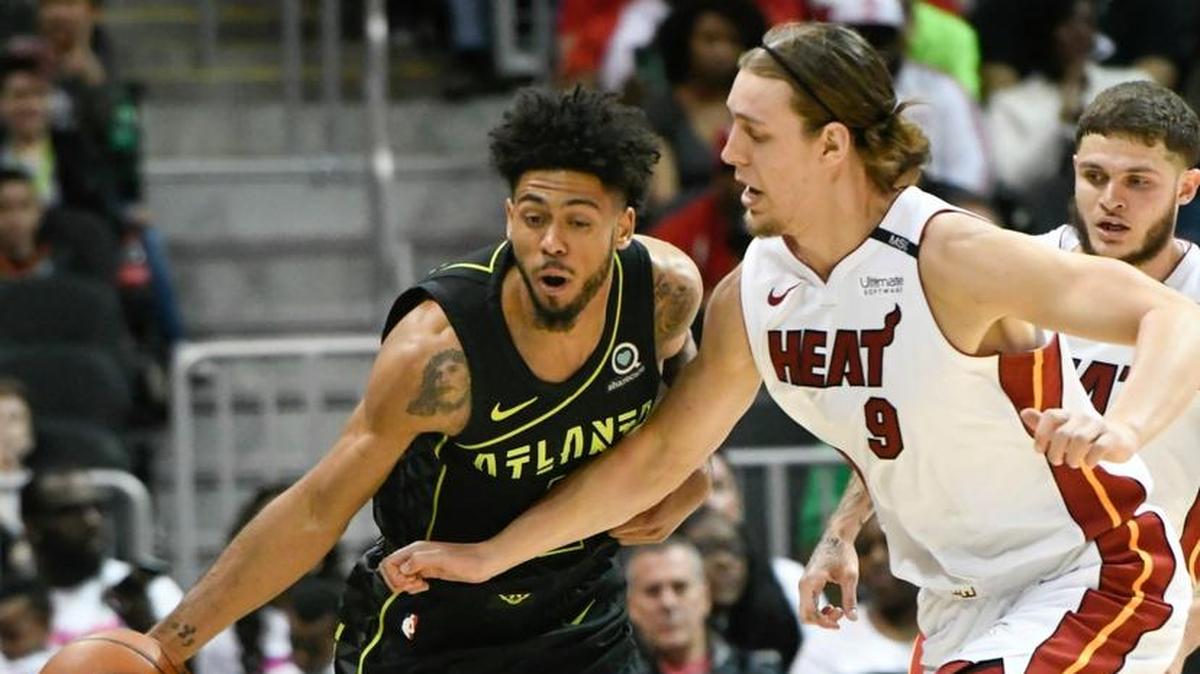 Atlanta Hawks guard Tyler Dorsey tries to get past Miami Heat forward Kelly Olynyk (9) during the first half of an NBA basketball game Wednesday, April 4, 2018, in Atlanta.