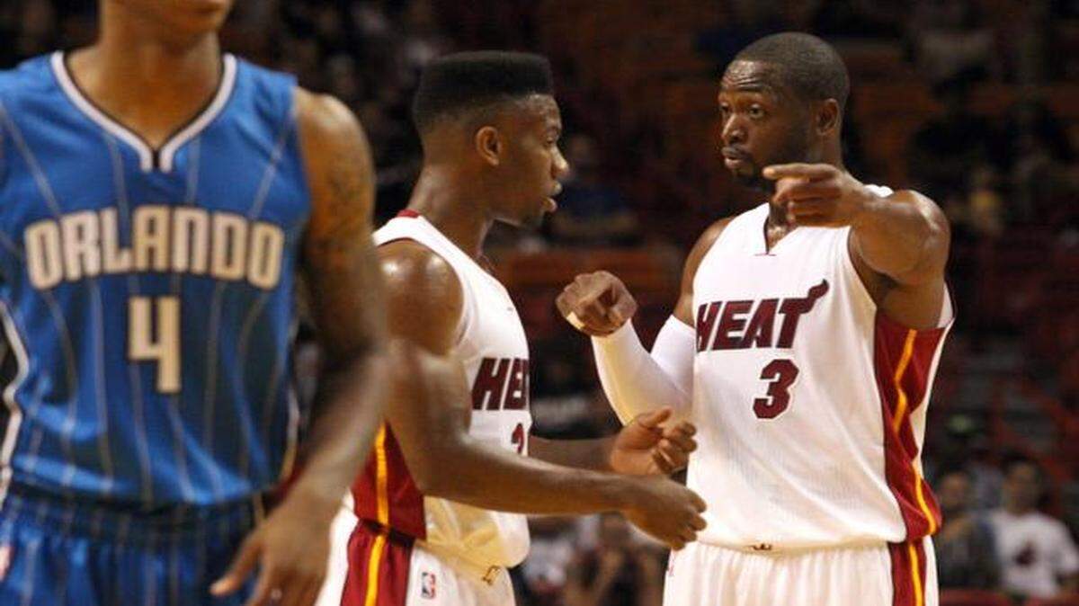 
 Dwyane Wade coaches Norris Cole in the first quarter during the Miami Heat's preseason game against the Orlando Magic at AmericanAirlines Arena in Miami on Tuesday, Oct. 7, 2014.
