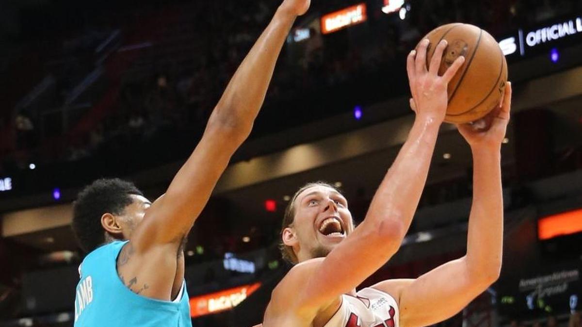 Miami Heat center Kelly Olynyk tries to push past Charlotte Hornets guard Jeremy Lamb under the basket in the first quarter of a preseason game at the AmericanAirlines Arena in Miami, Florida, October 9, 2017.