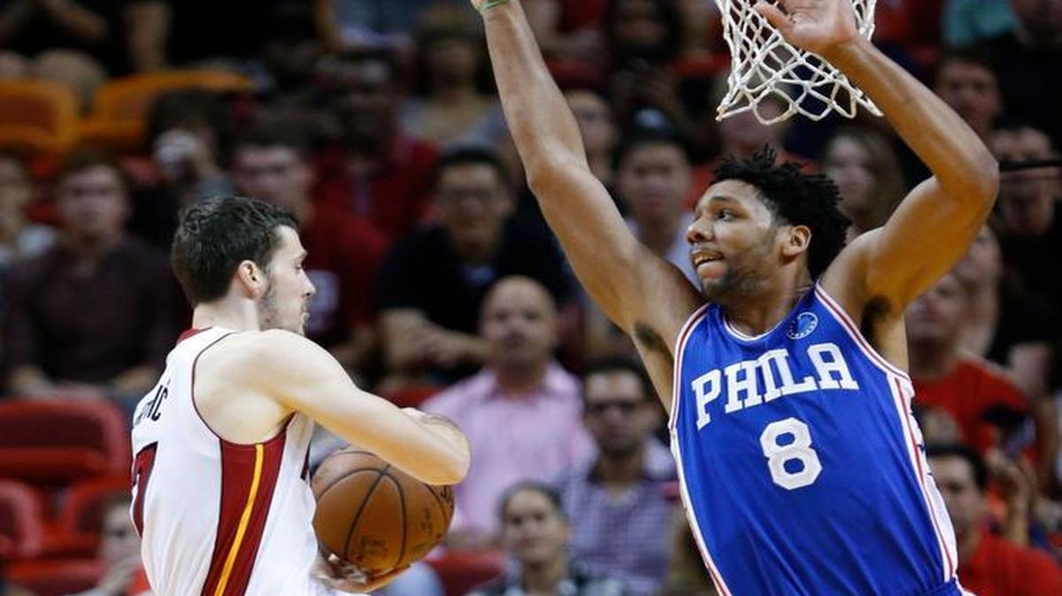 Philadelphia 76ers center Jahlil Okafor (8) attempts to block a shot by Miami Heat guard Goran Dragic during the first half of an NBA basketball game, Saturday, Nov. 21, 2015, in Miami.