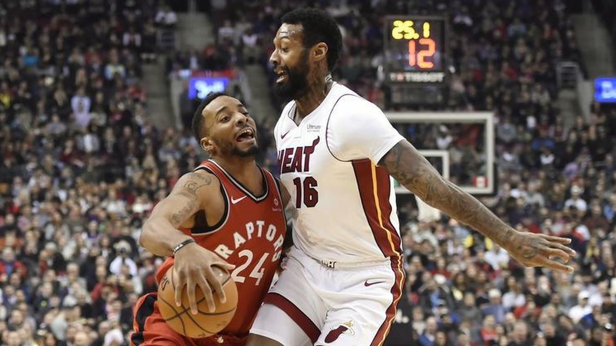 Toronto Raptors forward Norman Powell (24) tries to drive past Miami Heat forward James Johnson (16) during the first half of an NBA basketball game Tuesday, Jan. 9, 2018, in Toronto.