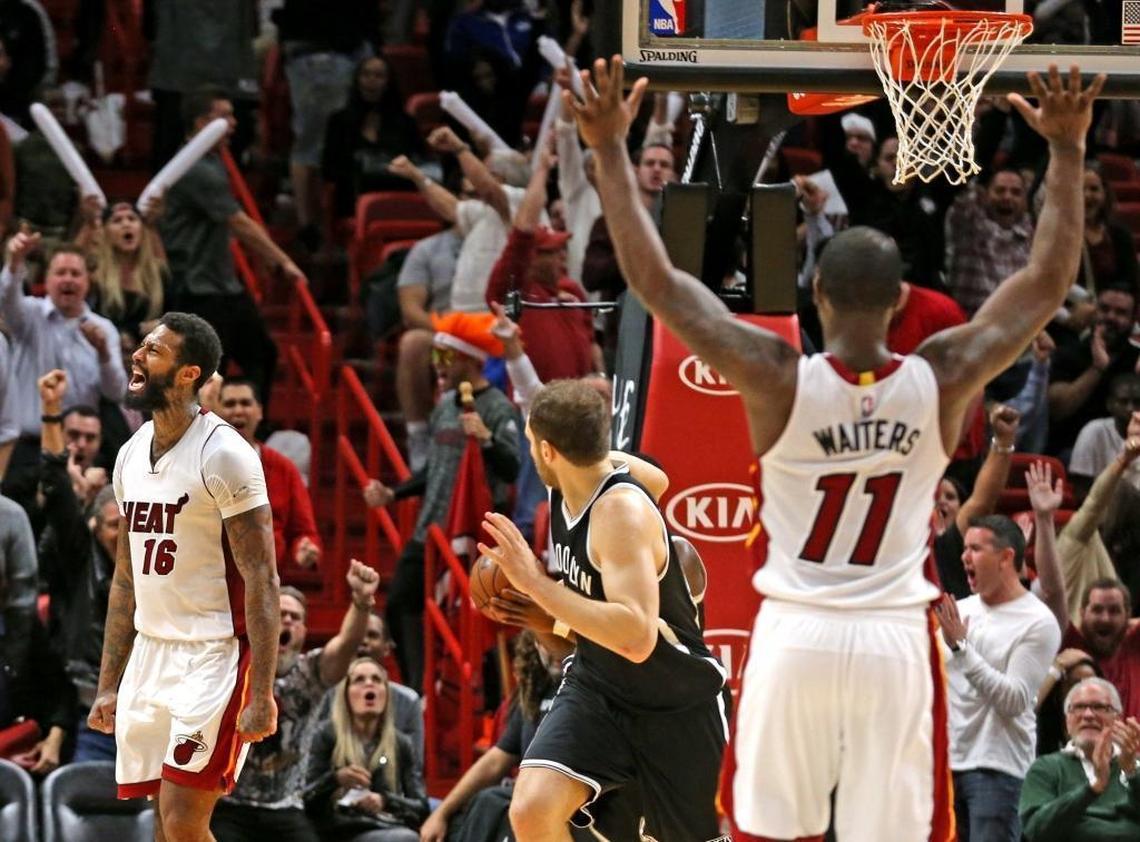Miami Heat Dion Waiters raises his hands after James Johnson screams after a major dunk in the final seconds of the fourth quarter as they defeat the Brooklyn Nets at the AmericanAirlines Arena in Miami, Florida, Jan. 30, 2017. After losing out on Gordon Hayward, the Heat now turn its attention to keeping Johnson and Waiters.