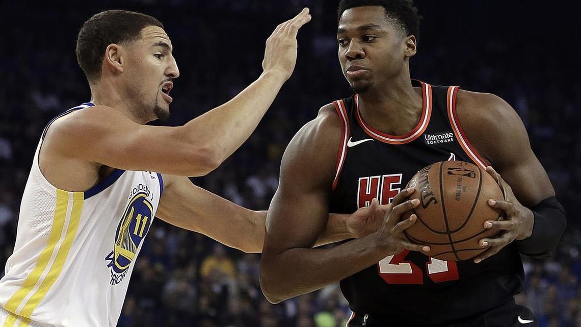 Golden State Warriors' Klay Thompson, left, defends against Miami Heat center Hassan Whiteside during the first half of an NBA basketball game Monday, Nov. 6, 2017, in Oakland, Calif.