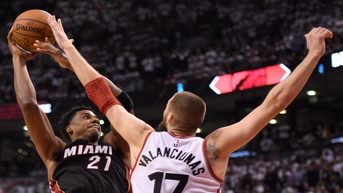 Toronto Raptors' Jonas Valanciunas (17) stops Miami Heat's Hassan Whiteside during overtime NBA playoff basketball action in Toronto on Thurs., May 5, 2016.