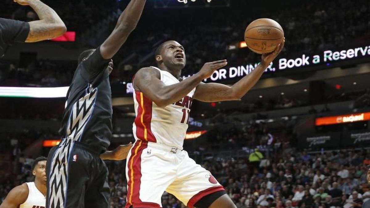 Miami Heat guard Dion Waiters (11) on a lay up past Minnesota Timberwolves forward Gorgui Dieng (5) in the first quarter as the Miami Heat host the Minnesota Timberwolves at the American Airlines Arena on Fri., March 17, 2017.