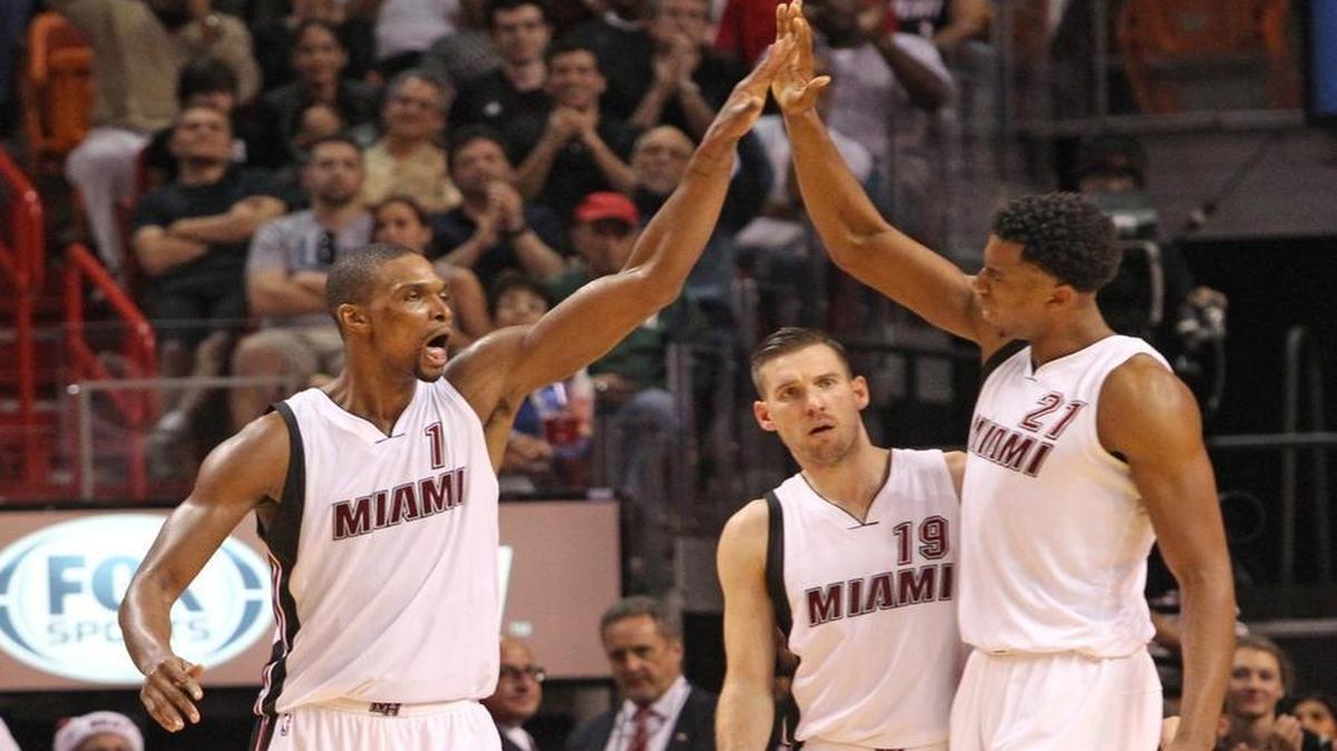 Chris Bosh and Hassan Whiteside celebrate in the fourth quarter of the Miami Heat’s game against the Portland Trail Blazers on Sunday, December 20, 2015 at AmericanAirlines Arena.